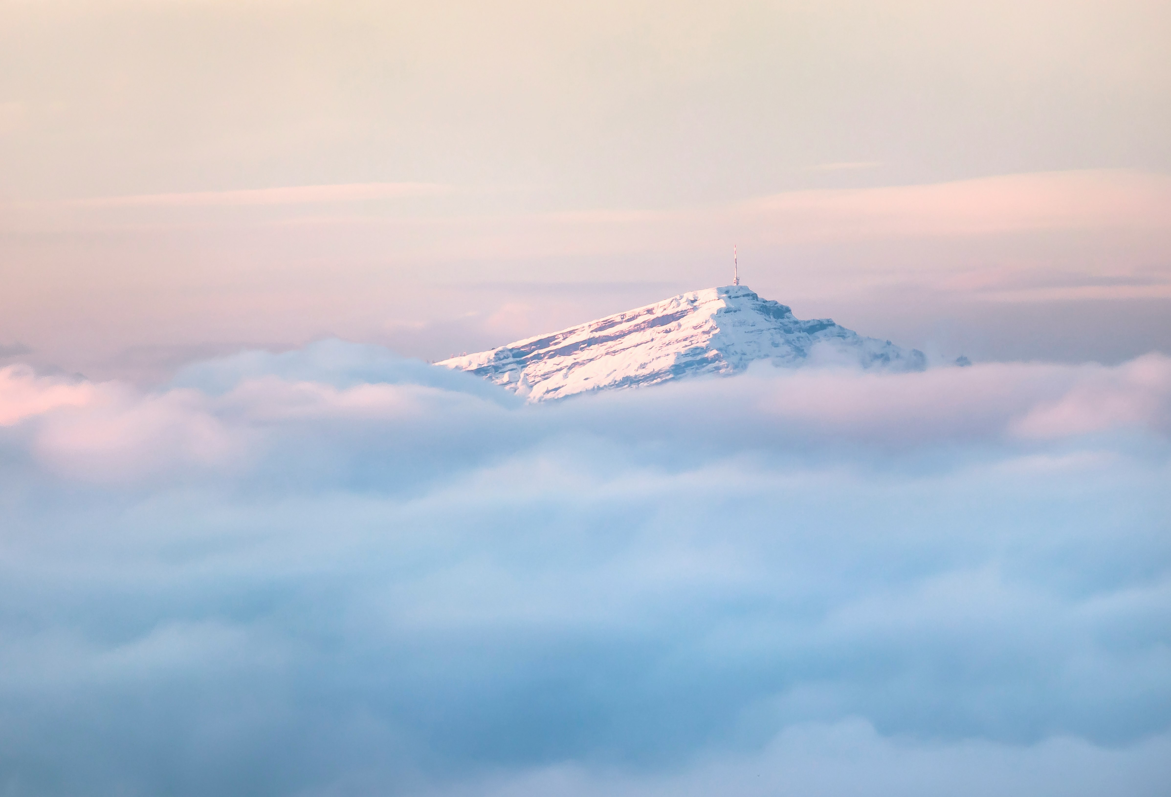 snow covered mountain under cloudy sky during daytime